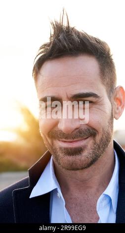 Portrait of a handsome mature man looking at the camera outdoors. Spanish person with nice smile Stock Photo