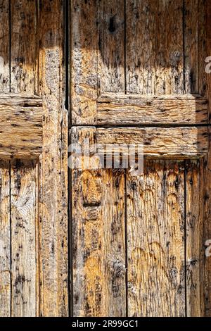 Front door of abandoned traditional village house in Halki, a small town on Naxos, Greece. Close up with textured weathered wood. Stock Photo