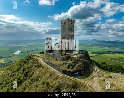 Aerial view of the remains of Hazmburk medieval castle with a circular and rectangular tower sit at the summit of this low peak hiking spot with sceni Stock Photo