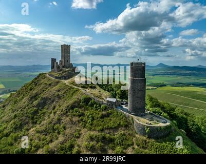 Aerial view of the remains of Hazmburk medieval castle with a circular and rectangular tower sit at the summit of this low peak hiking spot with sceni Stock Photo