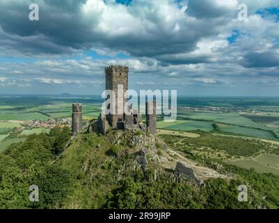 Aerial view of the remains of Hazmburk medieval castle with a circular and rectangular tower sit at the summit of this low peak hiking spot with sceni Stock Photo