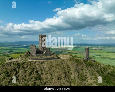 Aerial view of the remains of Hazmburk medieval castle with a circular and rectangular tower sit at the summit of this low peak hiking spot with sceni Stock Photo