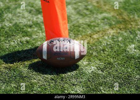 Wilson American Footballs next to an Orange Corner Pylon on an artificial turf Stock Photo