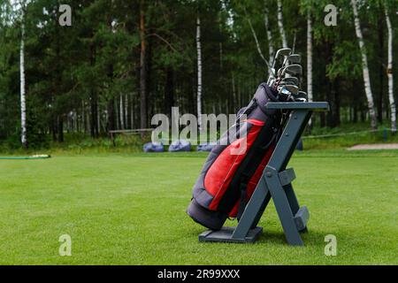 Golf Bag With Bunch of Golf Clubs in the Golf Course. Stock Photo