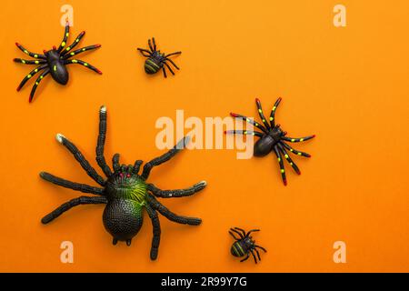 Group of black toy spiders on a orange background for halloween Stock ...