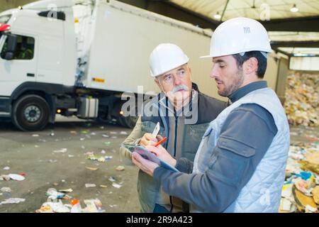 recycling workers talking in the factory Stock Photo