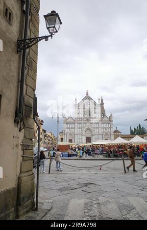 Florence, Italy - 22 Nov, 2022: Christmas Market in Piazza Santa Croce and the Basilica di Santa Croce di Firenze Stock Photo