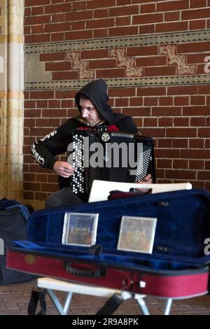 Amsterdam, NL - OCT 12, 2021: Group of street musicians performing in Amsterdam, Netherlands. Stock Photo