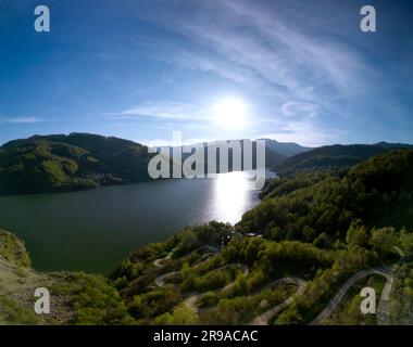 Panoramic aerial shot of Siriu Lake in Romania during early may on a sunny day. Cinematic drone shot Stock Photo