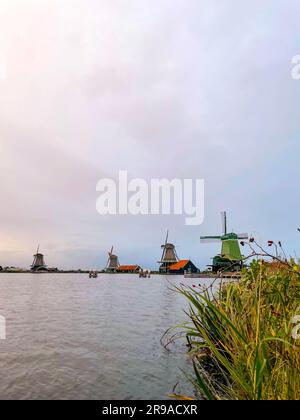 Zaanse Schans is a neighbourhood of Zaandam, near Zaandijk, Netherlands, famous for its collection of well-preserved historic windmills and houses. Stock Photo