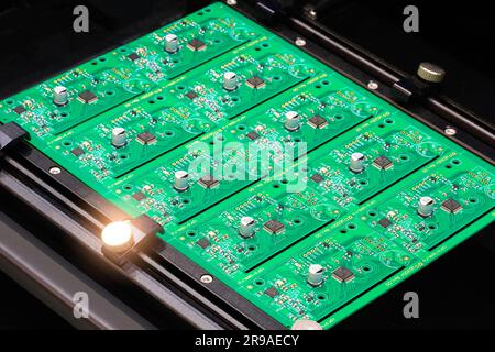 Close up of examining of test sample of microchip transistor under the microscope in laboratory. Equipment for testing microchips. Automation of produ Stock Photo