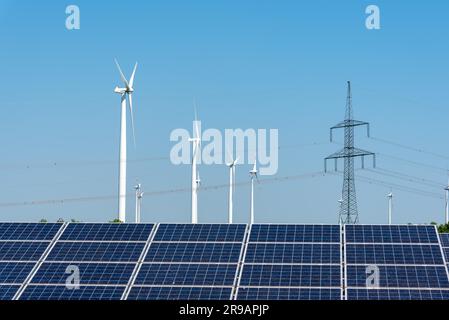 Electricity pylons, solar plants and wind turbines in Germany Stock Photo