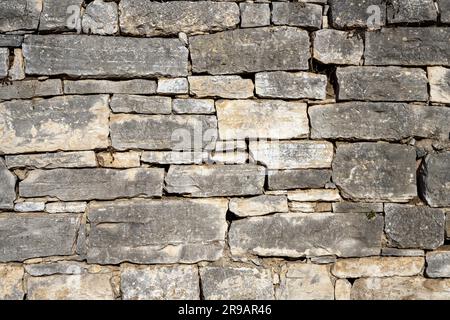 Background from an old and worn natural stone wall Stock Photo