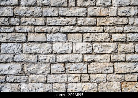 Background from a uniform natural stone wall Stock Photo