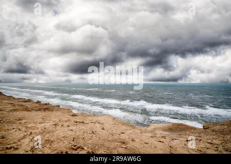 Dramatic weather over the sea with a rough coastal surface under a cloudy sky Stock Photo