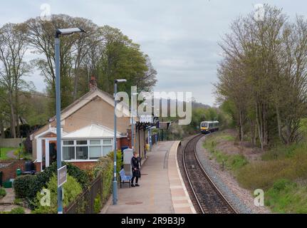 Little Kimble railway station with its single platform with a Chiltern Railways class 168 Turbostar train arriving with a single passenger Stock Photo