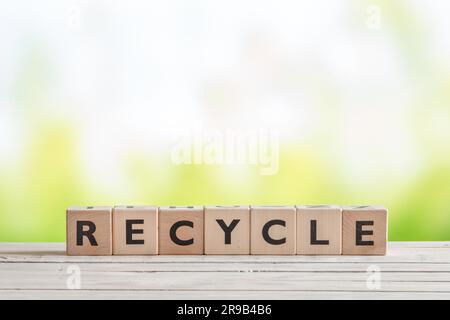 Recycle sign with blocks on a wooden table Stock Photo