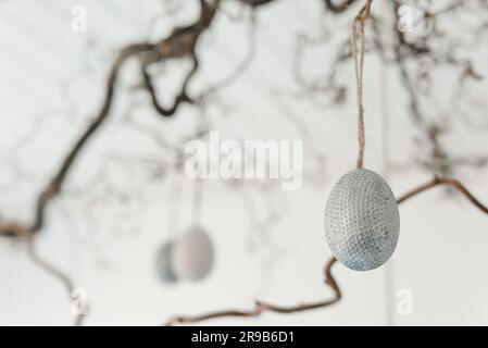 Decorative easter eggs hanging from a twig at easter Stock Photo