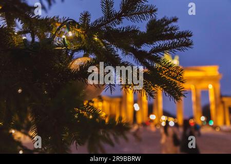 The famous landmark of Brandenburg Gate or Brandenburger Tor in Berlin, bokeh effect with christmas lights at night Stock Photo