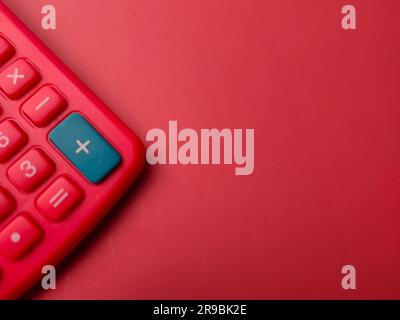 Top view red calculator on a red background with copy space Stock Photo