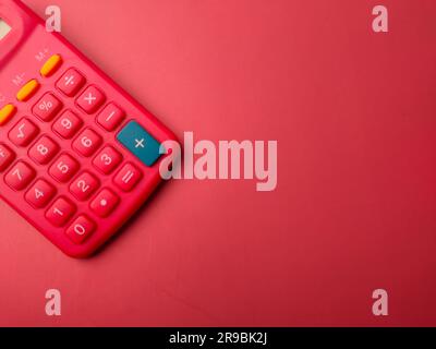 Top view red calculator on a red background with copy space Stock Photo