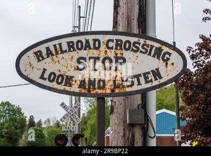 An old, rusty railroad crossing stop look and listen sign on a pole in Titusville, Pennsylvania, USA Stock Photo