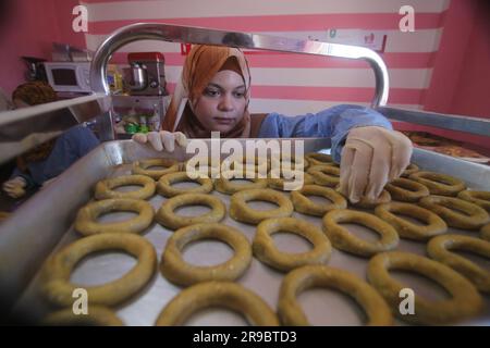 Gaza. 25th June, 2023. A Palestinian woman makes traditional cookies ahead of Eid al-Adha in the southern Gaza Strip city of Rafah, on June 25, 2023. Credit: Khaled Omar/Xinhua/Alamy Live News Stock Photo