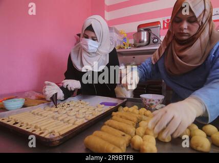 Gaza. 25th June, 2023. Palestinian women make traditional cookies ahead of Eid al-Adha in the southern Gaza Strip city of Rafah, on June 25, 2023. Credit: Khaled Omar/Xinhua/Alamy Live News Stock Photo