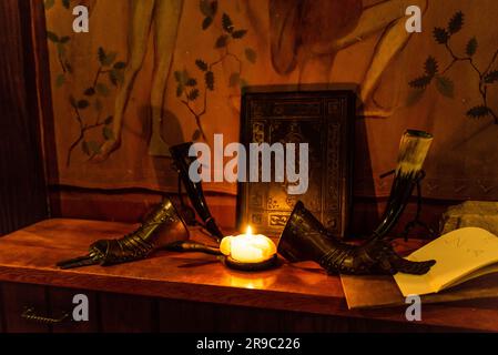 low key image of beautiful queen or king hand armor in front of old book fantasy medieval period. Stock Photo