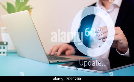 Man using laptop at the table. update the operating system to a newer one. Systems engineer Stock Photo