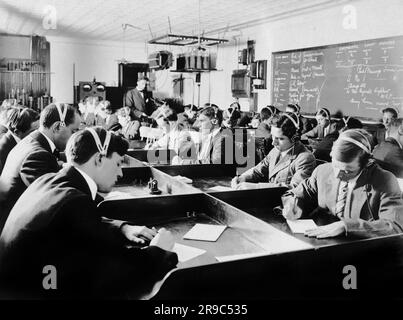 New York, New York:  c. 1916 Students at the first Marconi Wireless School in the United States in New York. The new law after the Titanic disaster requiring operators to be on board all ocean liners assures the men of a position when they graduate. Stock Photo