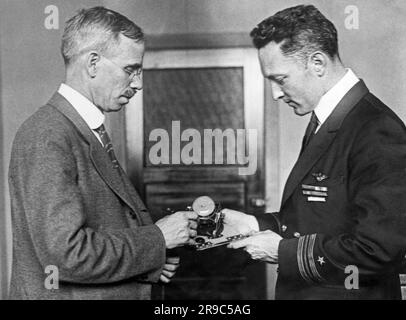 Washington, D.C.:  November 30, 1929 Scientist and inventor A. H. Bumstead presents a sun compass to Commander Richard Byrd for his flight over the North Pole. Whereas normal magnetic compasses are helpless at the poles, this simple device showed the explorer the way on both of his flights over the North and South Poles. Stock Photo