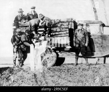 Rochester, New York:  March 30, 1933 Striking milk farmers dump their milk along the roadside in protest of the low prices being from wholesalers. Stock Photo