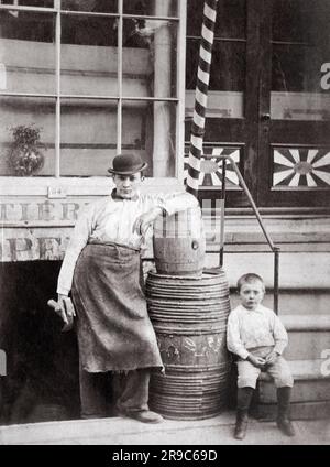 New Yor, New York:  c. 1890 A cabinet card of a cooper and his son outside his work shop. Stock Photo