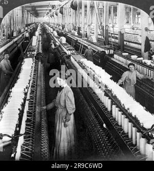 Greensboro, North Carolina:  1903 Women and girls working in the spinning room with 60,000 spindles in the White Oak Cotton Mill. Stock Photo