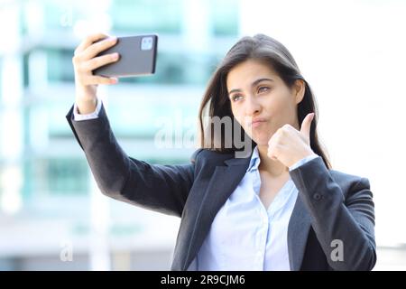Believed executive taking selfie in the street Stock Photo