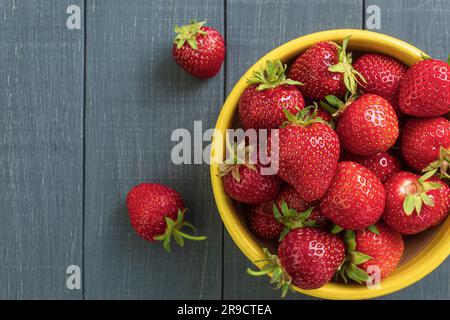 Fresh strawberries on a wooden table, close-up. View from the mountain. Juicy strawberries lie on a wooden table. Copy space Stock Photo