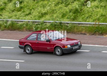 1990 90s nineties Red Ford Escort XR3i Popular; travelling at speed on the M6 motorway in Greater Manchester, UK Stock Photo