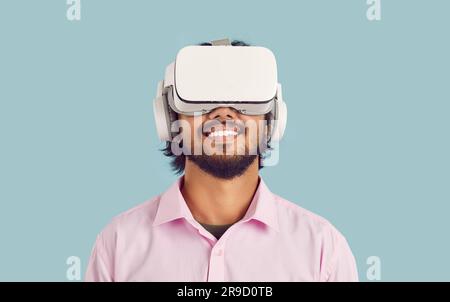 Smiling man in VR glasses watch digital reality Stock Photo