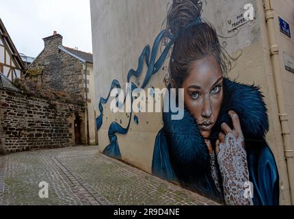 mural in a narrow lane with the portrait of a beautiful woman on a facade in the small town of Morlaix in Brittany, France Stock Photo