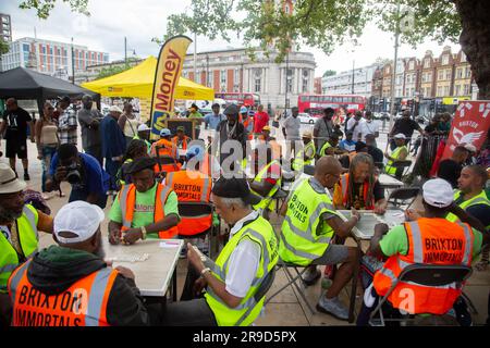 London, UK. 24th June, 2023. People paly dominos in Windrush Square on the 75th Windrush Generation anniversary. The Windrush Generation are mostly Afro-Caribbean people who arrived between 1948 and the early 1970s in the first great wave of black immigrants in the UK. Credit: SOPA Images Limited/Alamy Live News Stock Photo