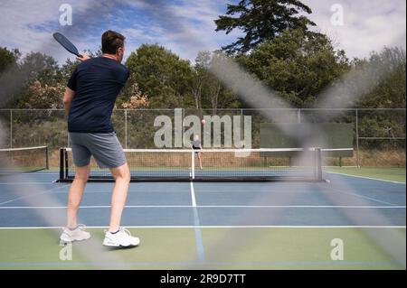 Two People Playing Pickleball on a Sunny Day Stock Photo