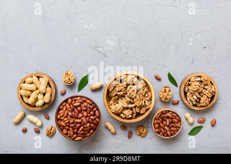 Walnut kernel halves, in a wooden bowl. Close-up, from above on colored background. Healthy eating Walnut concept. Super foods with copy space. Stock Photo