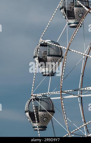 A classic Ferris wheel against a vibrant blue sky. Stock Photo