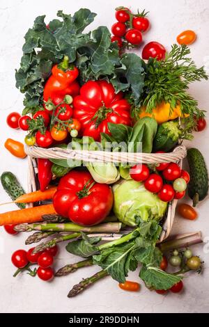 Basket of fresh vegetables on the white background. Top view Stock Photo
