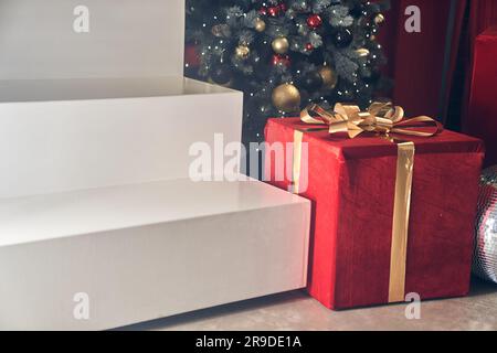 Rectangular white podium for the presentation of goods with space for copying. Minimalistic podium scene in the form of a ladder on the background of a Christmas tree with balloons. High quality photo Stock Photo