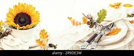 Table setting decoration for autumn holiday with flower and leaves Stock Photo