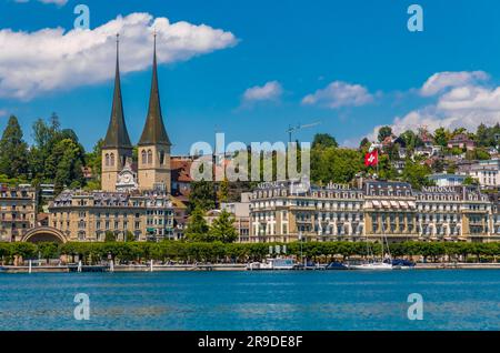 Lovely view of the right lake shore of Lucerne with the Church of St. Leodegar (German: Hofkirche St. Leodegar) on a nice sunny day with a blue sky. Stock Photo