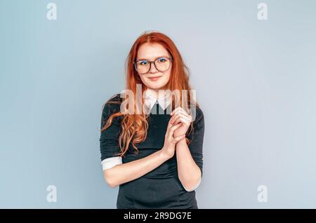 Woman with long red hair in glasses. Teacher. Education, teaching. Librarian Stock Photo