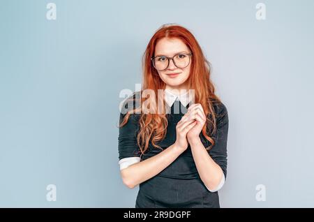 Woman with long red hair in glasses. Teacher. Education, teaching. Librarian Stock Photo